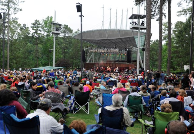 Crowd at the Koka Booth Amphitheatre surrounded by beautiful pine trees