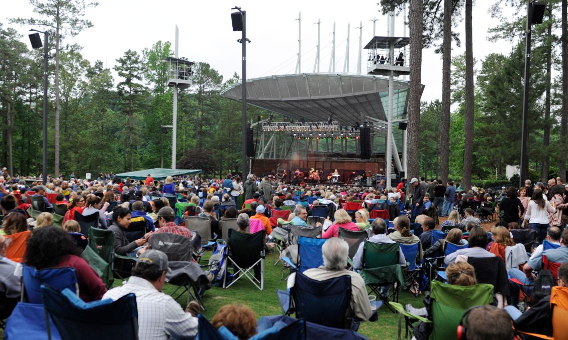 Crowd at the Koka Booth Amphitheatre surrounded by beautiful pine trees