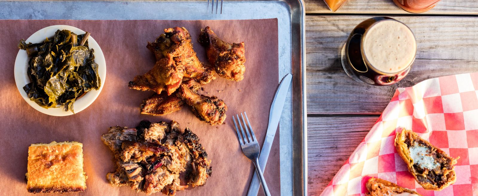 Brew N Que tray of chicken, spinach, cornbread and pulled pork with beer and potato skins on the side